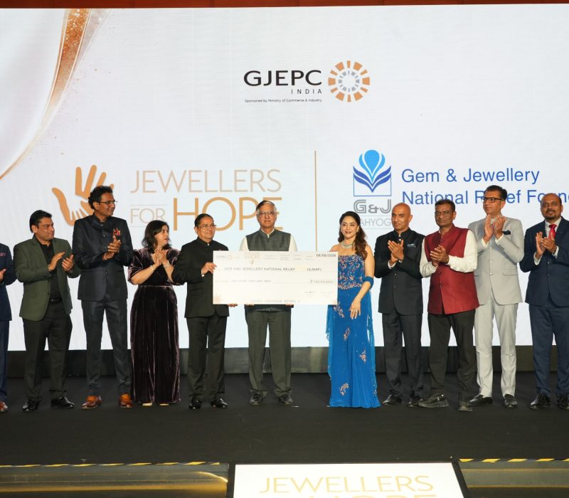 Kirit Bhansali Chairman GJEPC and Madhuri Dixit present the contribution to Shri Praveenshankar Pandya Chairman GJNRF in the presence of other dignitaries